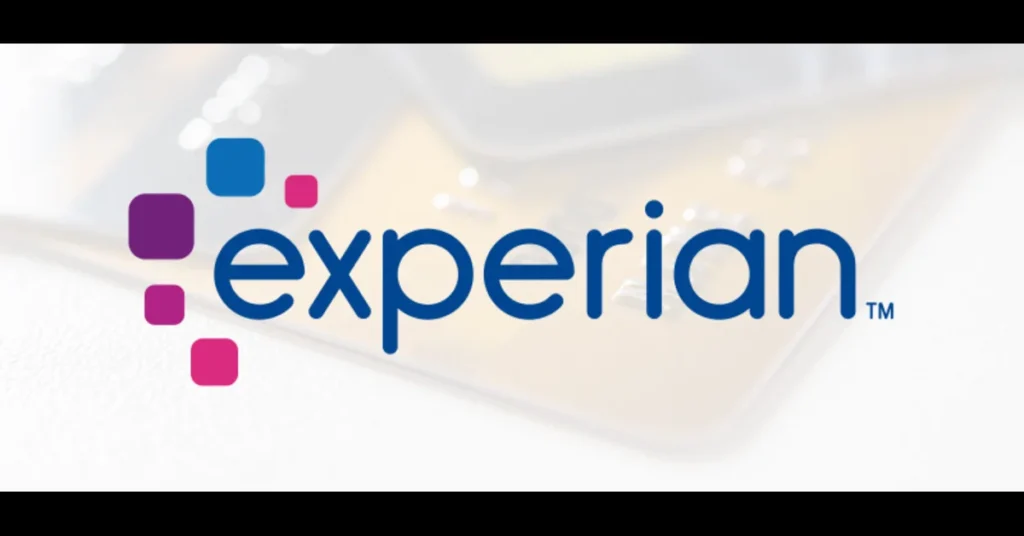 Experian logo with colorful square design on a blurred credit card background.