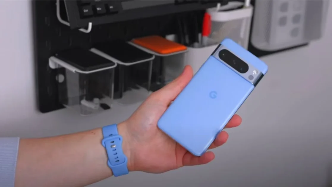 Person holding a blue Google Pixel 7a smartphone