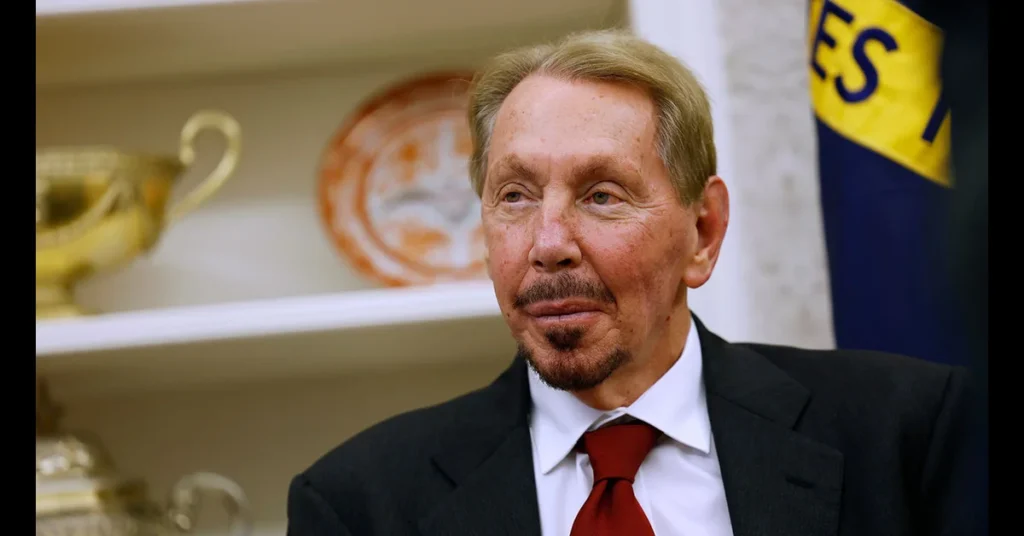 Larry Ellison speaking at a tech conference, standing at a podium with Oracle branding, highlighting his role in AI and cloud innovation.