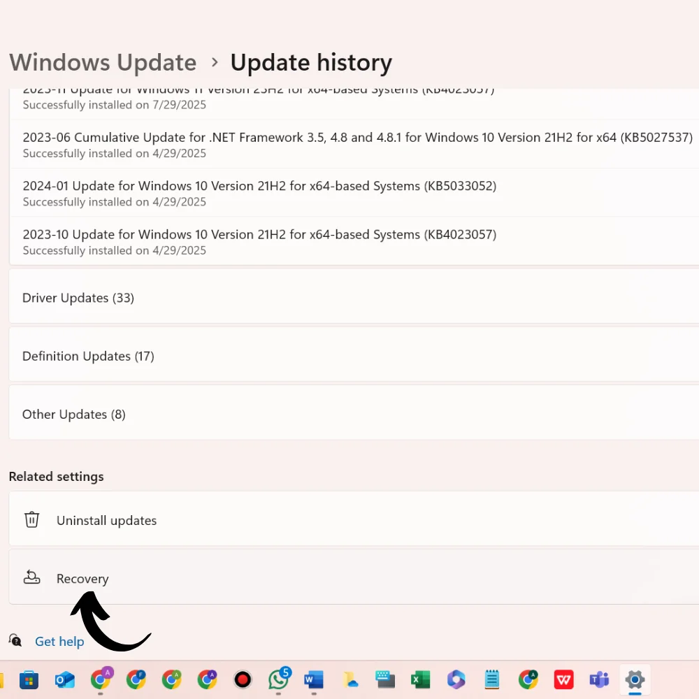 Windows Update history page showing installed updates with an arrow pointing to the "Recovery" option.