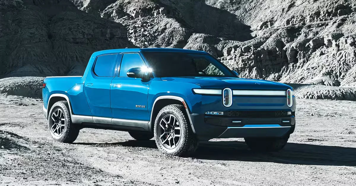 Blue Rivian electric truck parked on a scenic road, showcasing the brand’s EV design amidst a natural background, symbolizing innovation and sustainability.