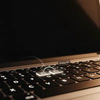 Close-up of Fn and F4 keys glowing on a laptop keyboard, symbolizing an accidental display toggle causing a black screen.