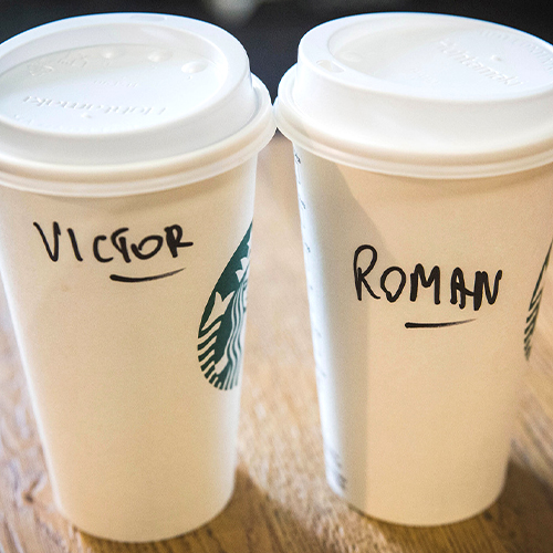 Starbucks coffee with names handwritten on them