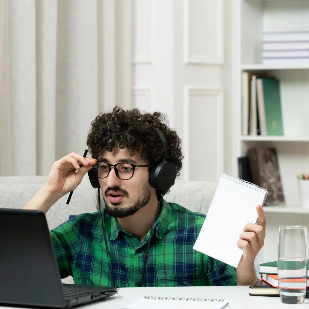 student-online-cute-young-guy-studying-computer-glasses-green-shirt-learning-with-pen